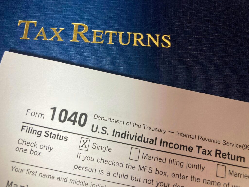 Industries We serve Close-up image of Form 1040 for U.S. tax returns, highlighting filing status options.